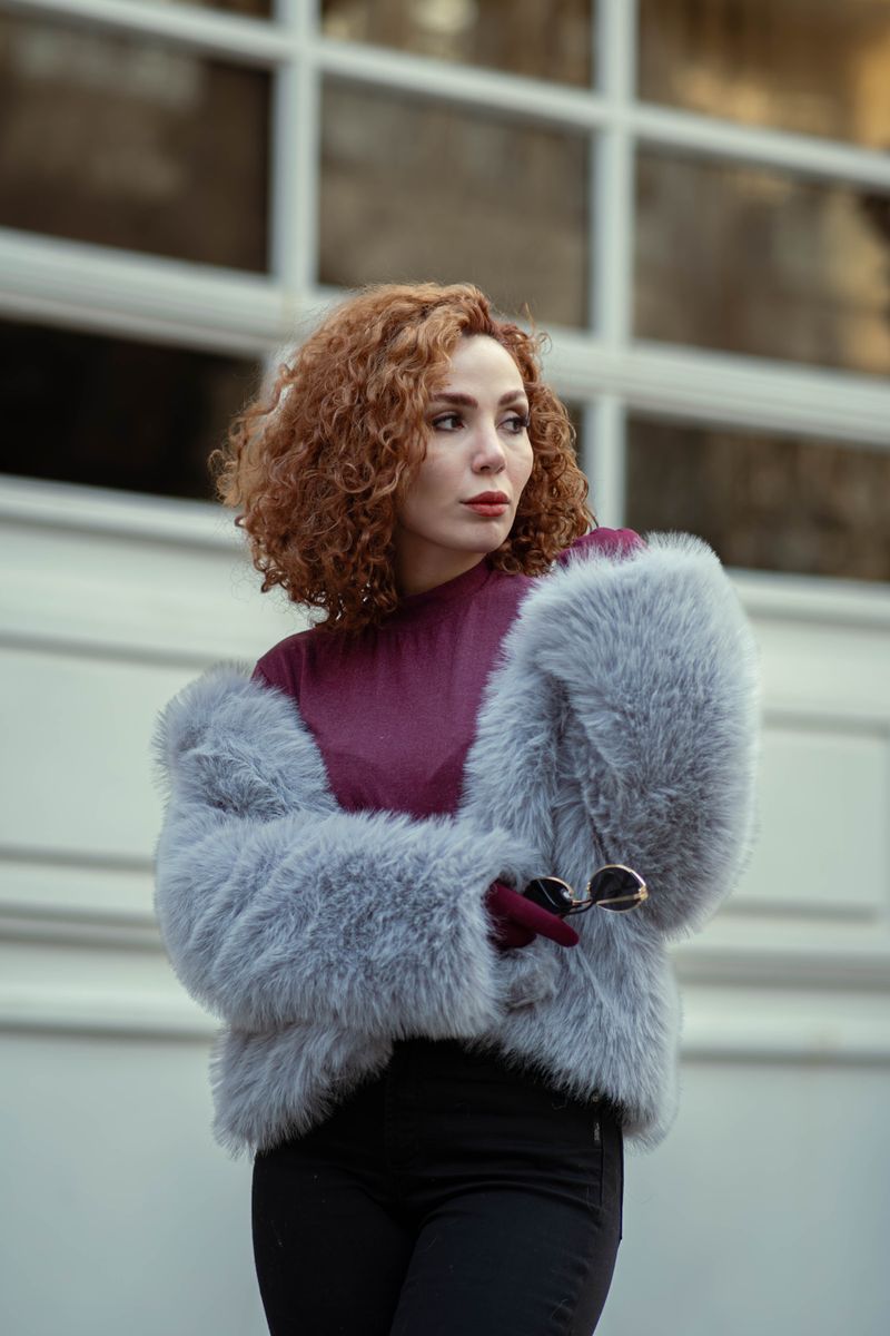 Woman in faux fur coat on city street
