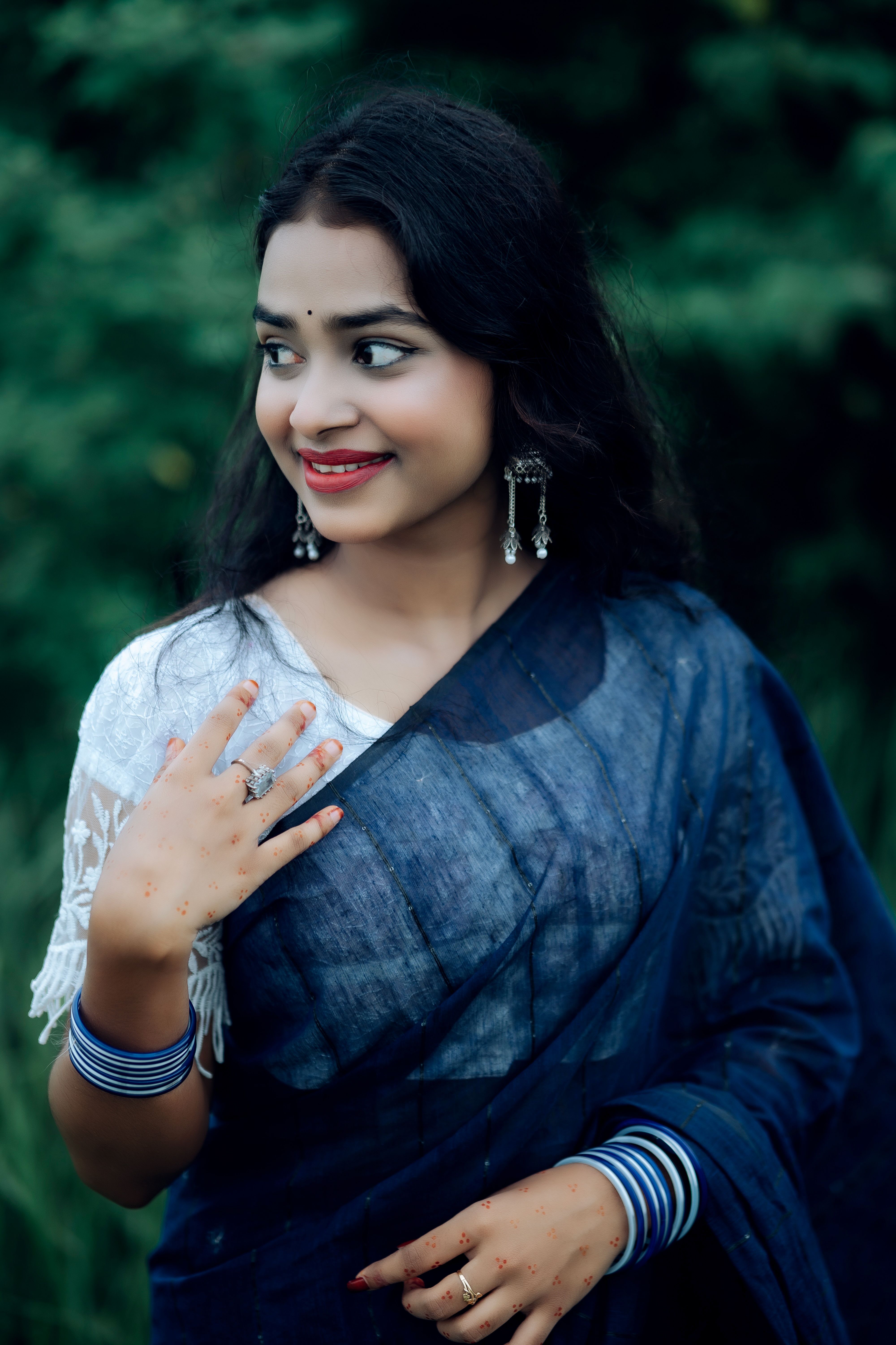 Woman in Traditional Blue Saree Smiling Outdoors · Free Stock Photo
