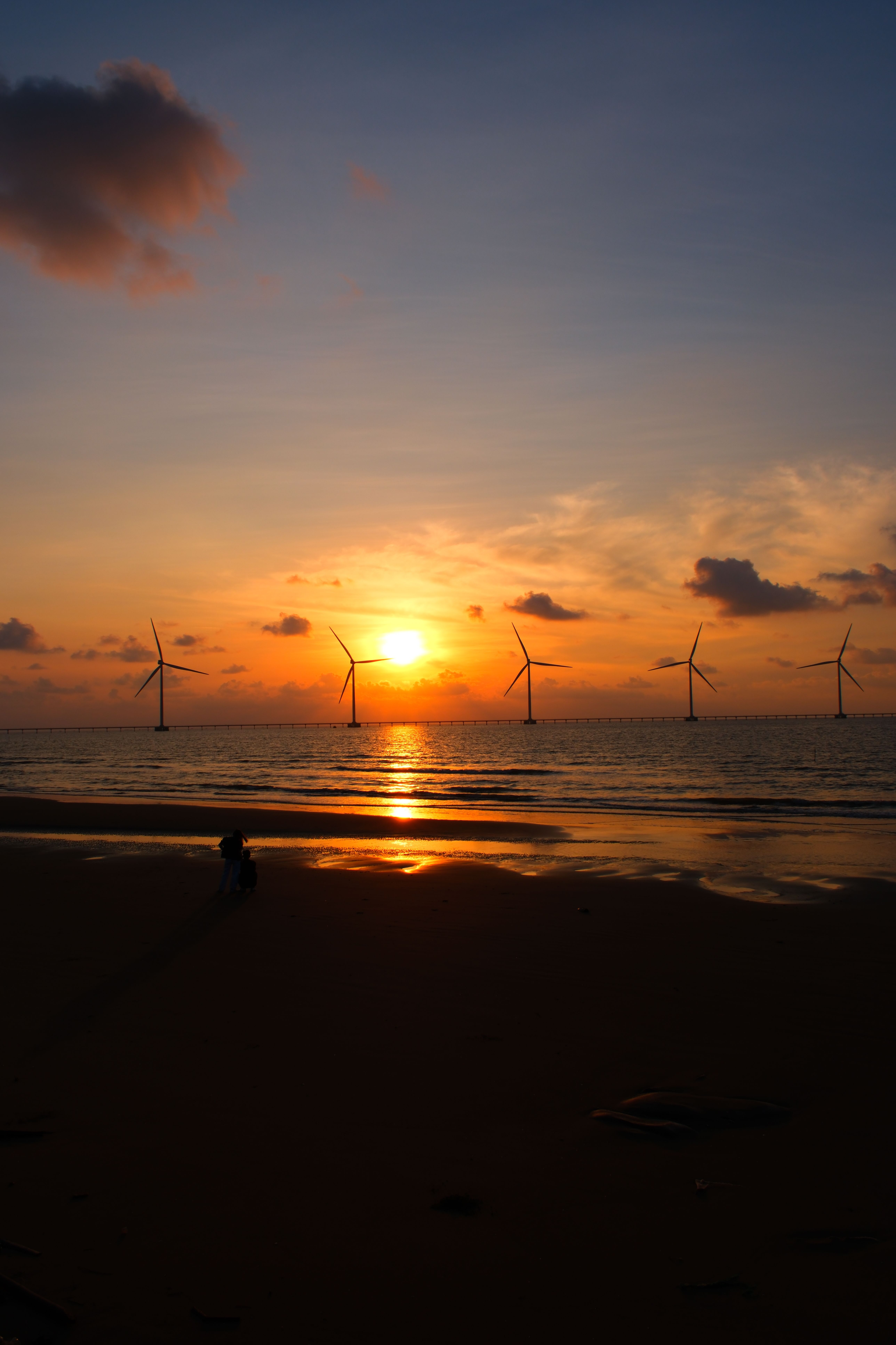 Scenic Sunset Over Wind Turbines at Beach · Free Stock Photo