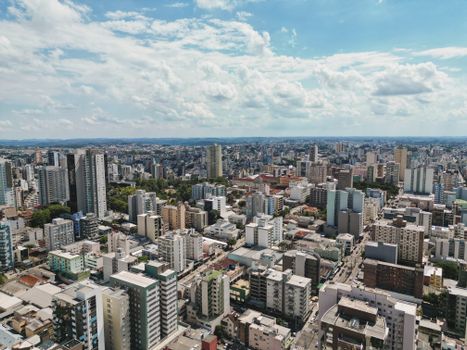 Stunning aerial view of Caxias do Sul showcasing modern buildings and sprawling urban landscape under a clear sky.