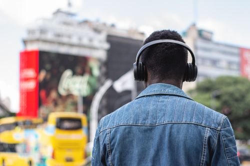 Free A person wearing headphones enjoys music in the bustling streets of Buenos Aires, Argentina. Stock Photo