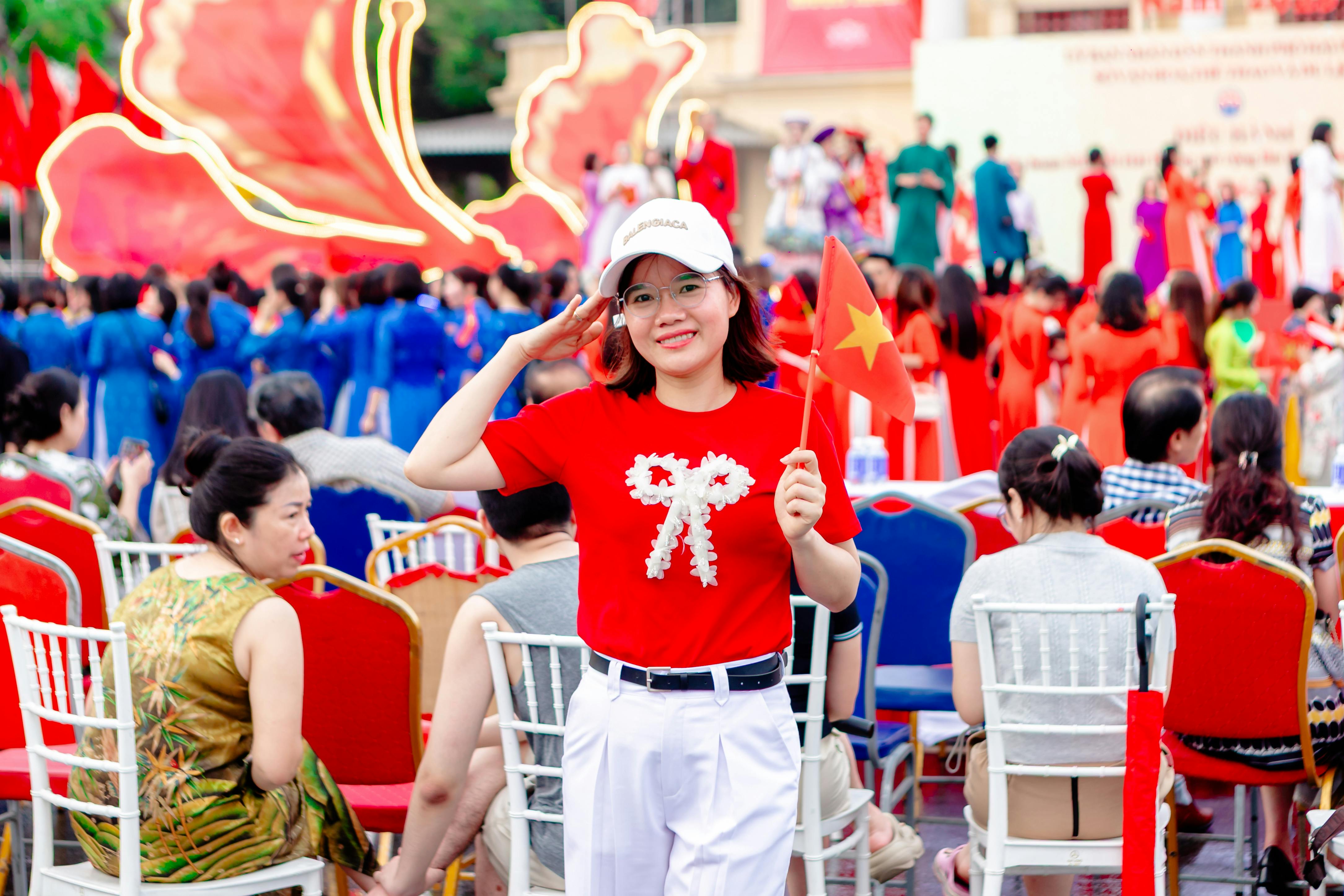 Vibrant celebration in Hải Phòng, Vietnam featuring people in colorful traditional attire and flags.