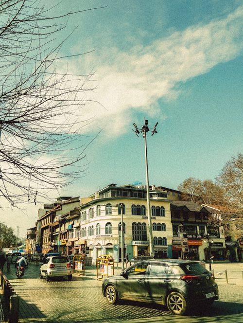 Free Street scene featuring vintage architecture under a clear sky. Stock Photo