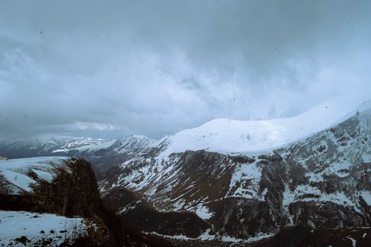 Stunning view of snow-covered mountains in Georgia during winter, capturing cold beauty and grandeur.