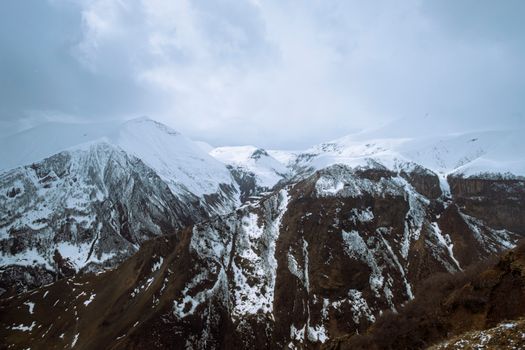 Majestic snow-covered mountains in Georgia's Caucasus range, showcasing breathtaking natural beauty.