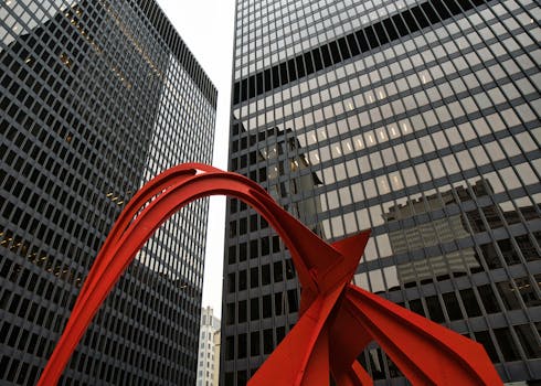 A striking red sculpture against modern skyscrapers in downtown Chicago, Illinois.