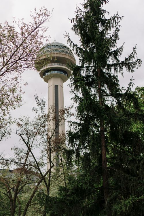 Free Scenic view of Ankara's Atakule Tower surrounded by lush trees, perfect for travel and tourism themes. Stock Photo