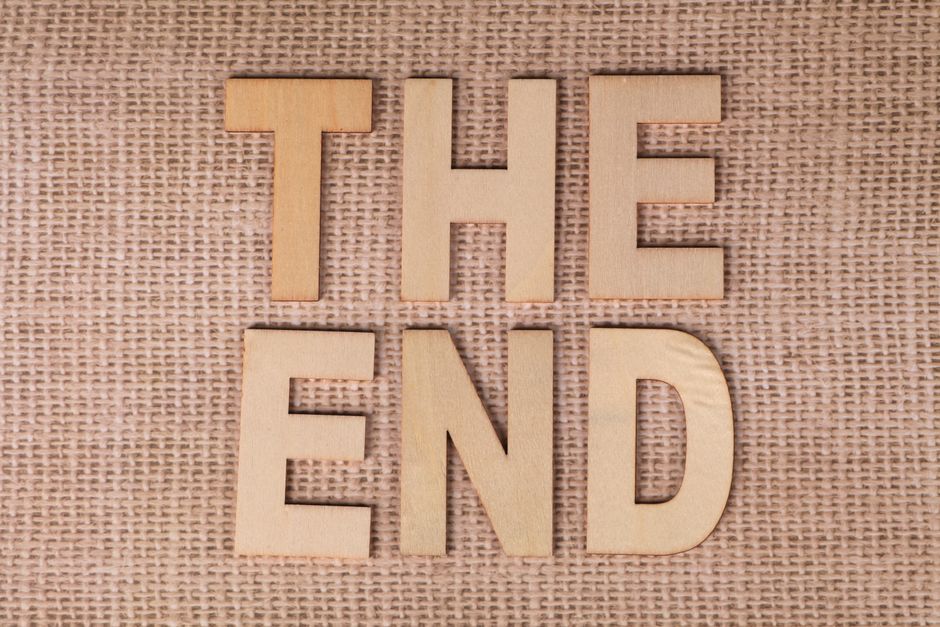 Wooden letters arranged to spell Wooden letters arranged to spell 'The End' on a burlap background.