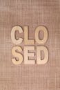 Wooden Letters on Burlap Background Saying Closed
