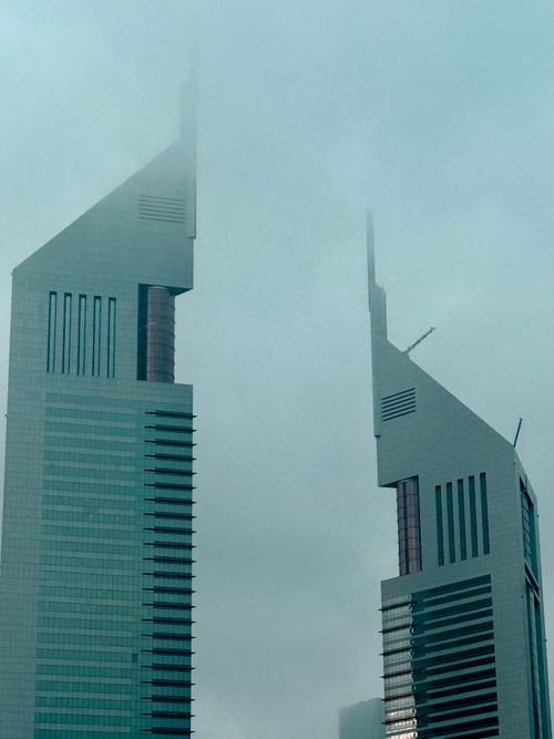 Free The Emirates Towers shrouded in fog in Dubai, offering a mysterious skyline view. Stock Photo