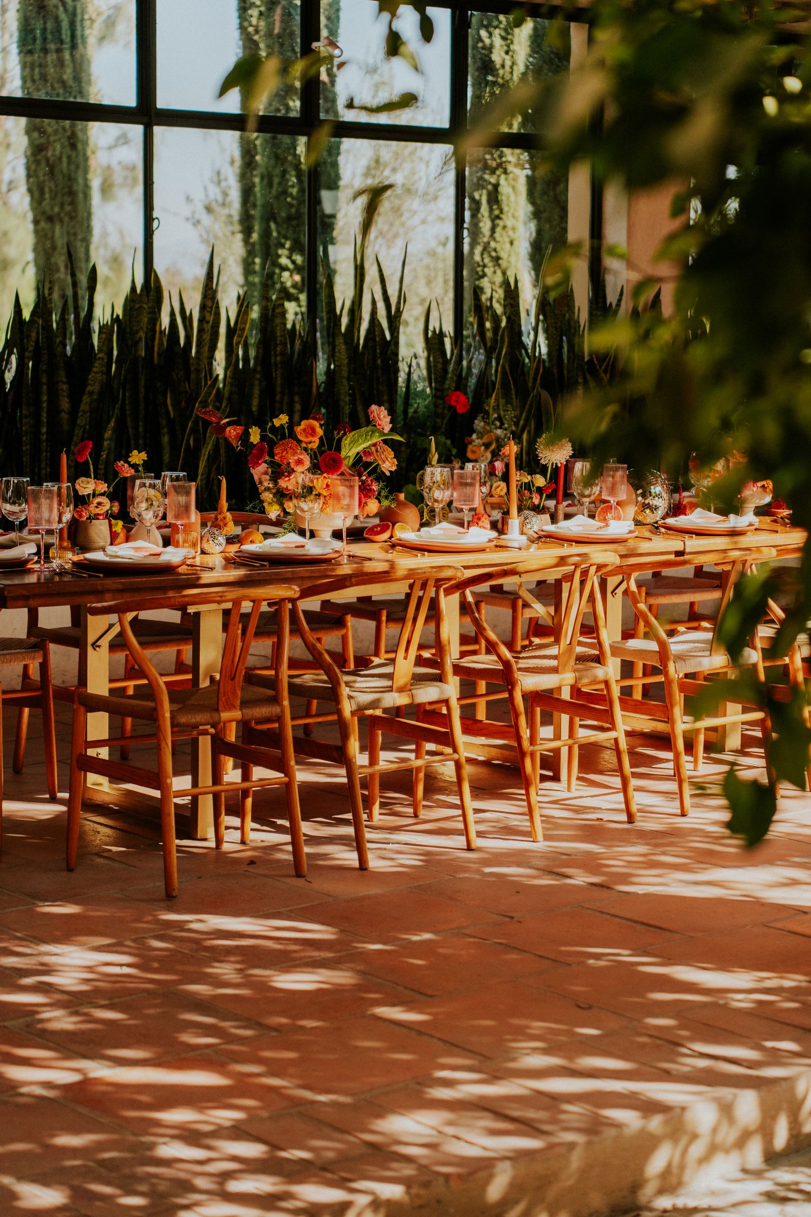 Warm wood chairs surrounding an outdoor wedding table