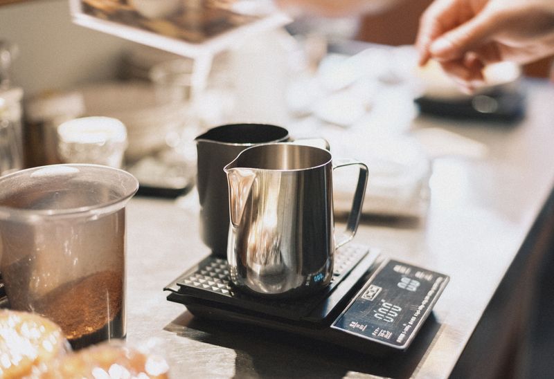 Barista weighing coffee for a careful brew at Grounded Coffee Co.