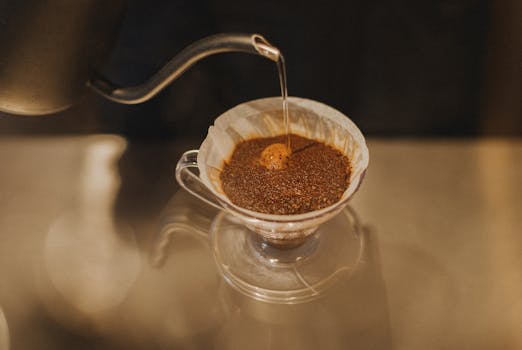 Close-up of a barista making pour-over coffee in a Tokyo café, showcasing artisan brewing.
