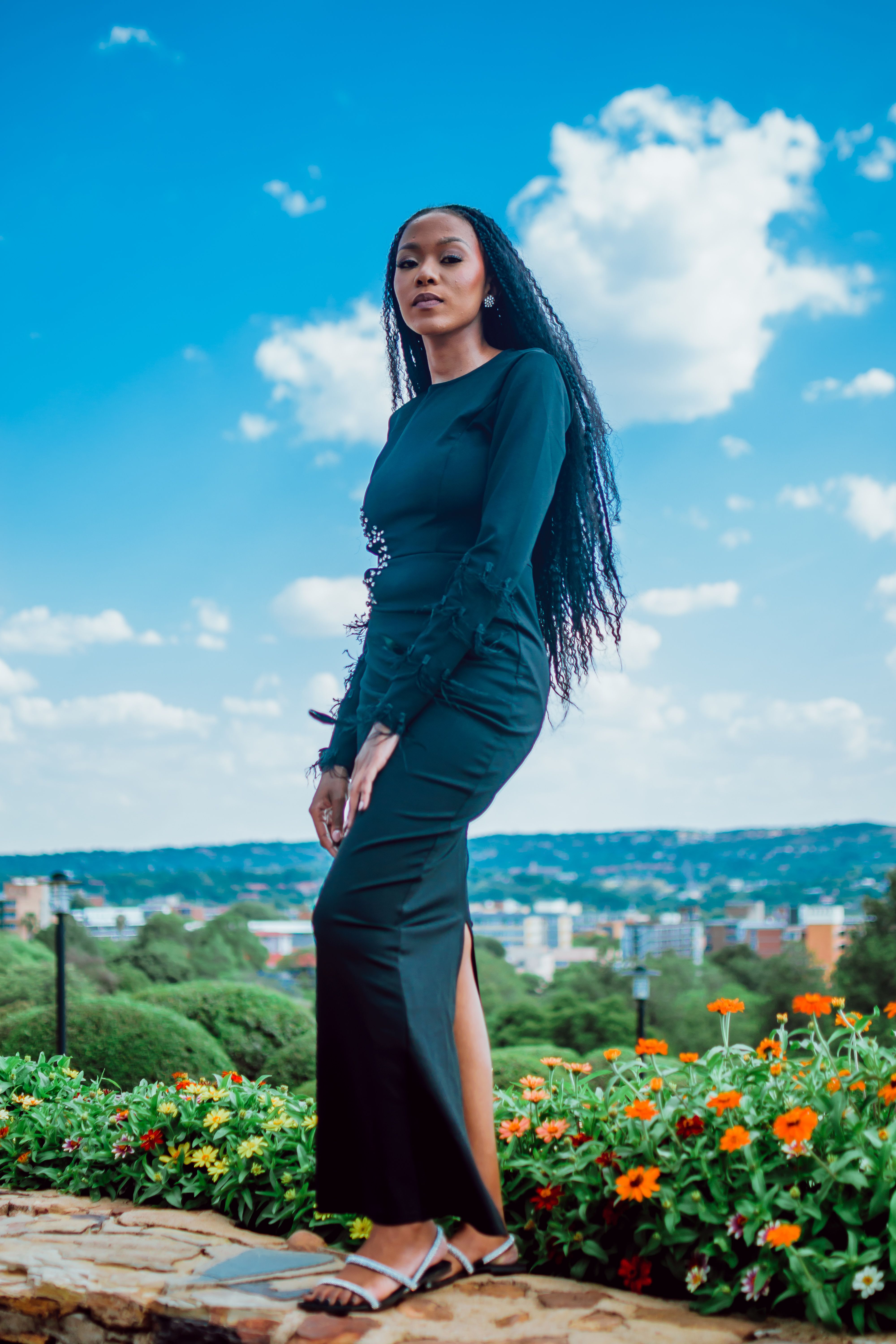 Elegant Woman in Black Dress Posing Outdoors · Free Stock Photo