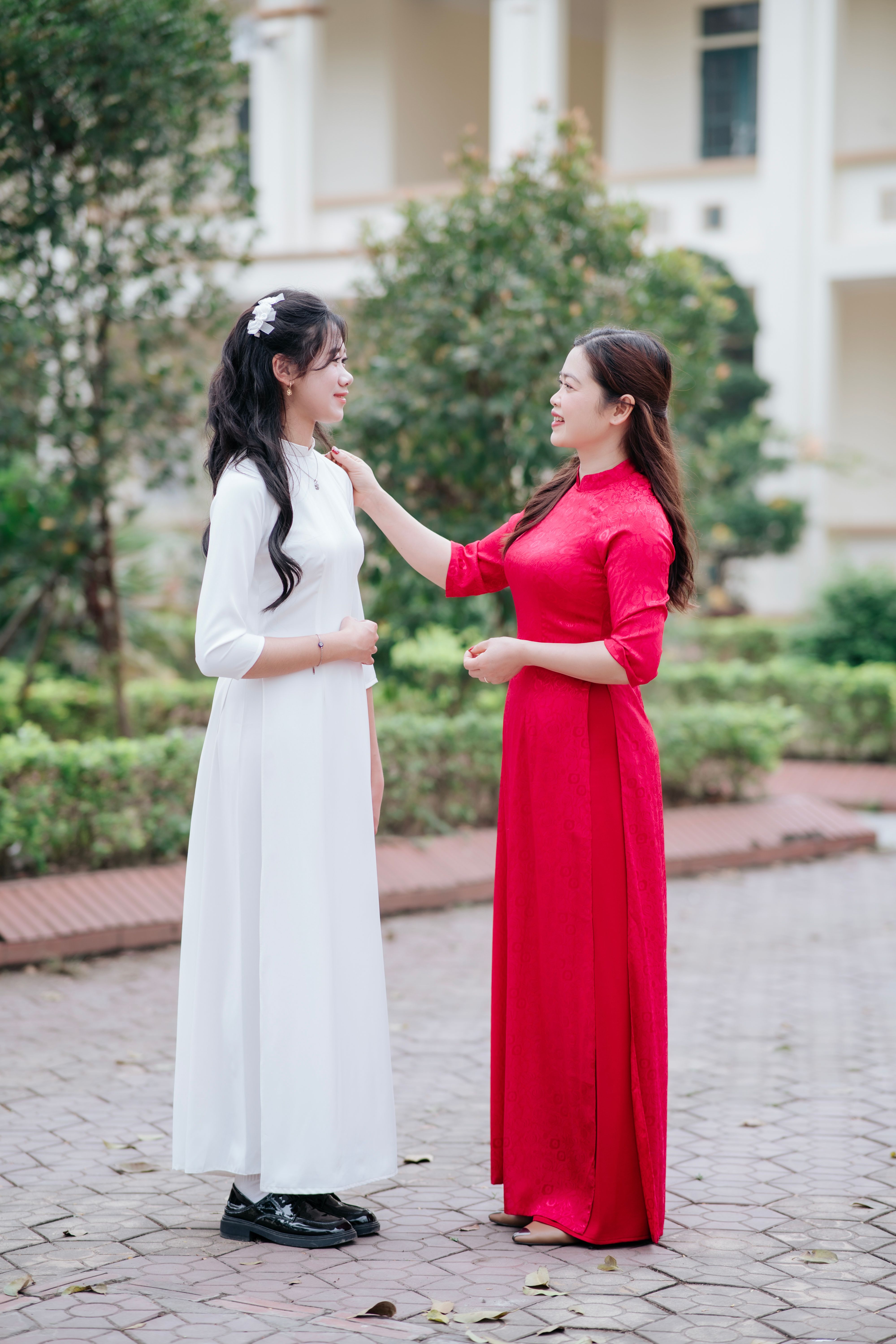 Two Women in Traditional Ao Dai Dresses Outdoors · Free Stock Photo