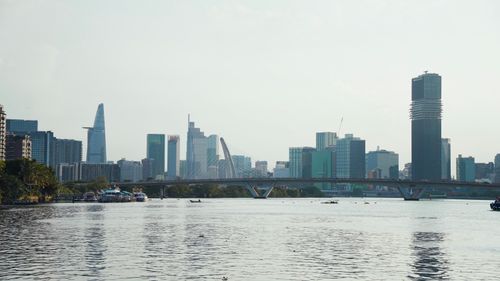 Free Stunning view of Ho Chi Minh City's modern skyline with a river in the foreground. Stock Photo