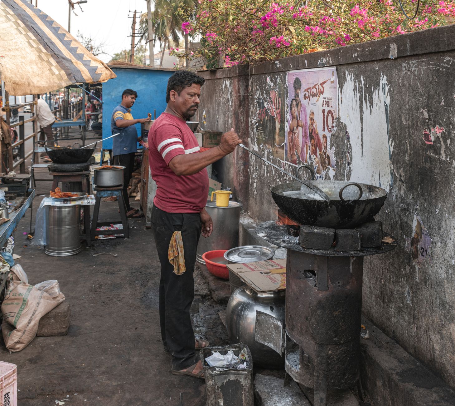 A street vendor prepares food at an outdoor stall in Badami, Karnataka, India.