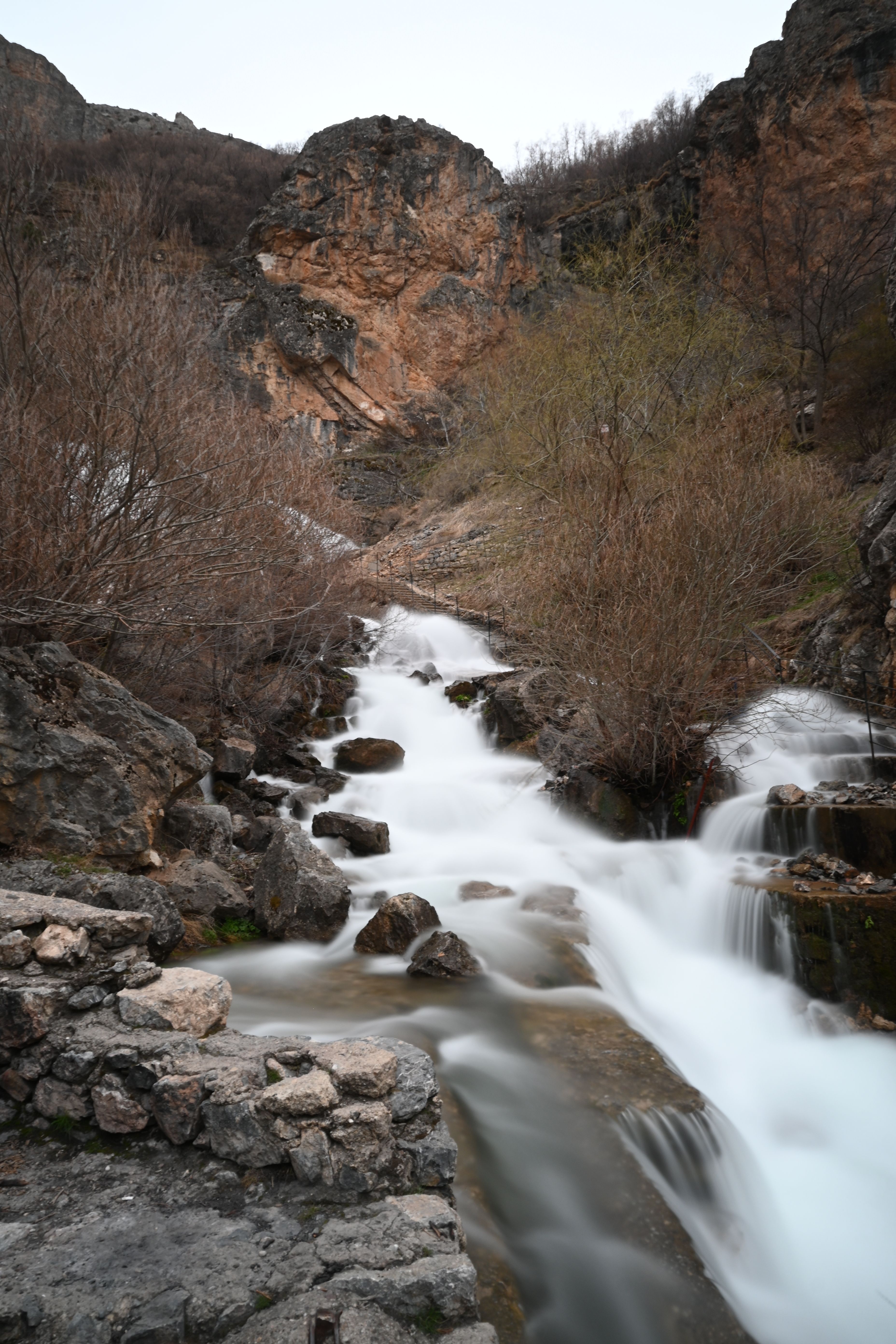 Calming waterfall flowing through rocky terrain, perfect for nature and travel themes.