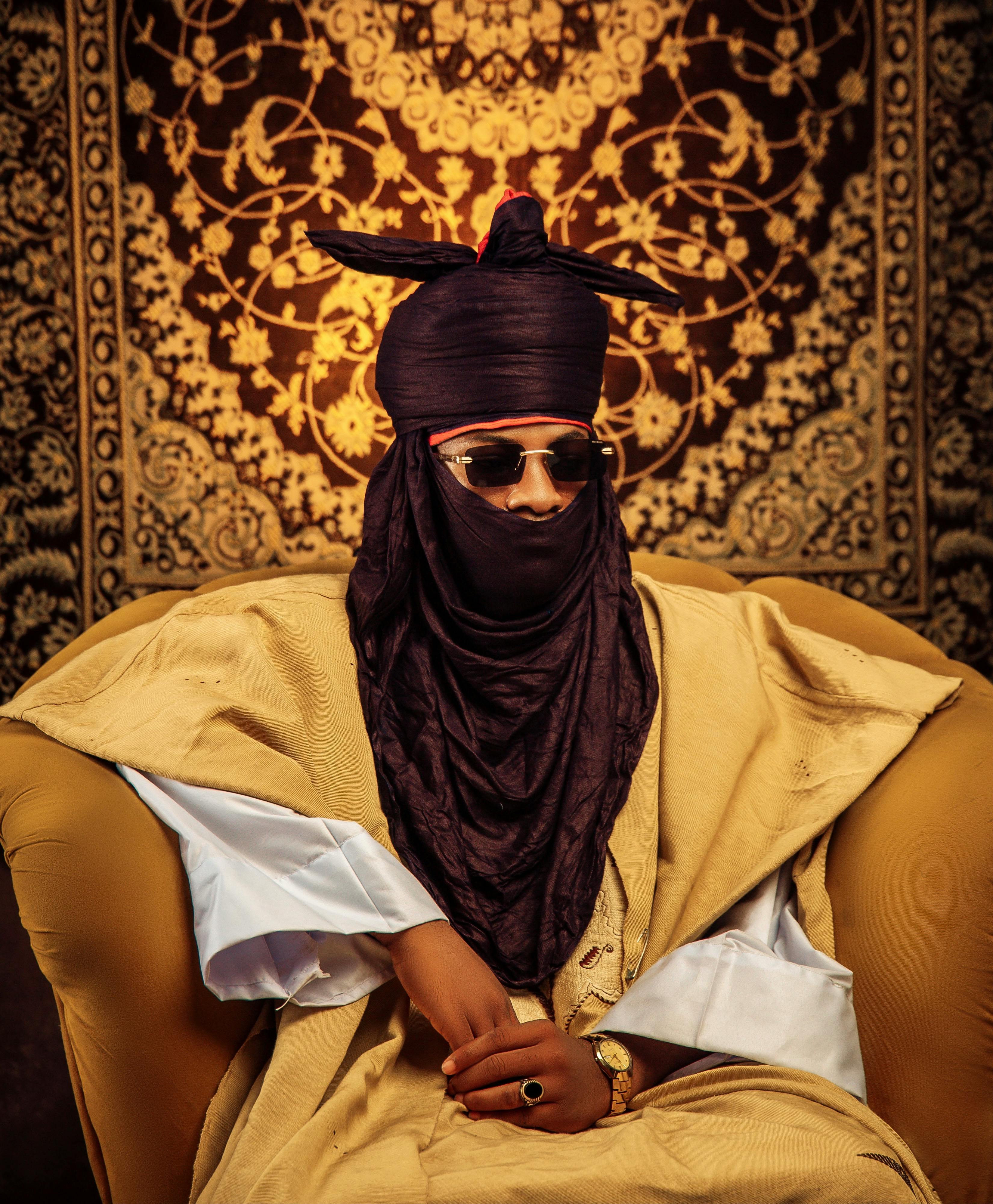 A striking portrait showcasing traditional African attire with intricate patterns and vibrant colors.