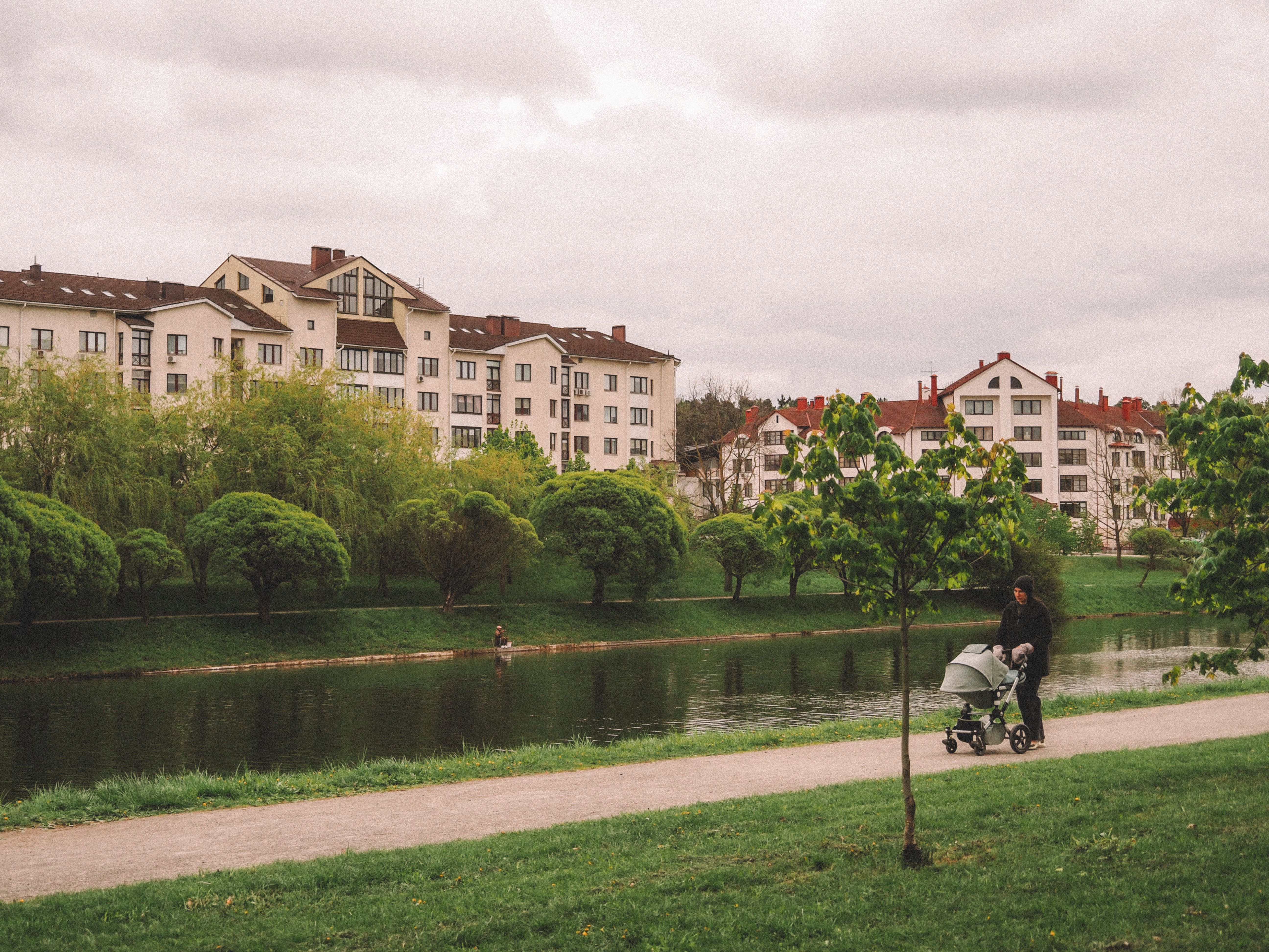 Stroller Walk by Riverside in Urban Park · Free Stock Photo