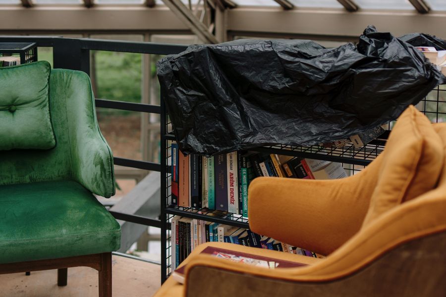 A cozy classroom reading nook with soft colorful chairs, books, and natural light