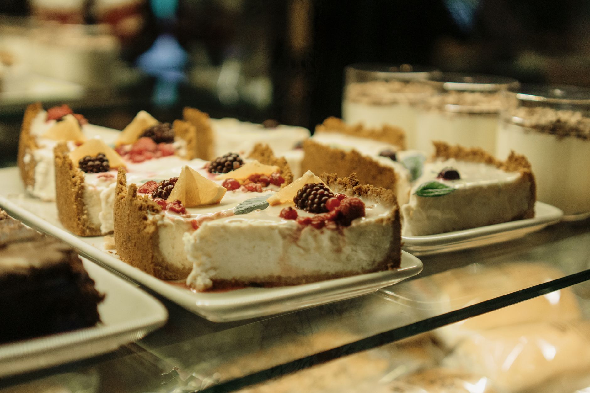 Close-up of blackberry cheesecake square with fresh berries on top