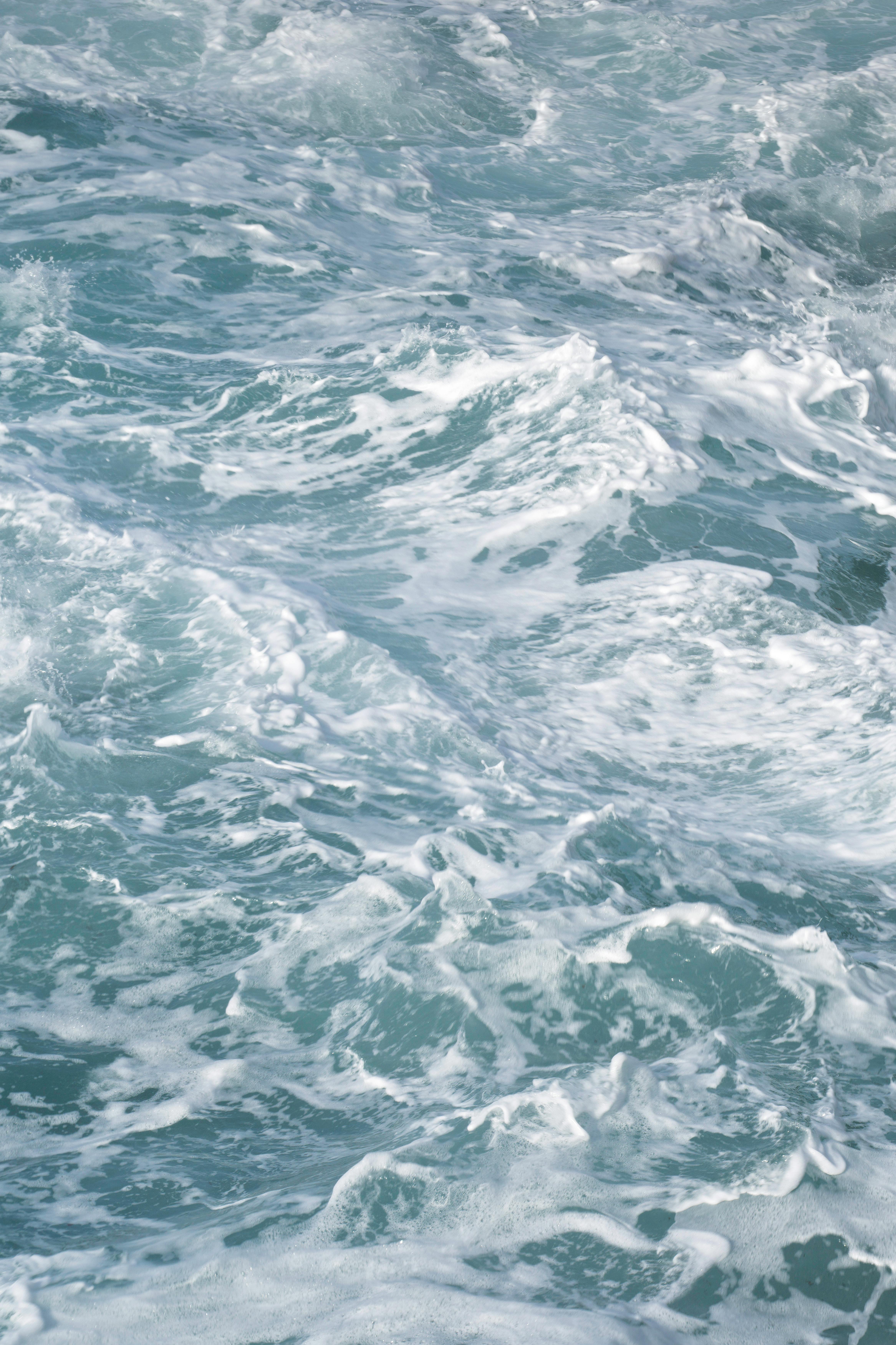 Captivating view of turbulent ocean waves creating a beautiful texture on a turquoise sea surface.