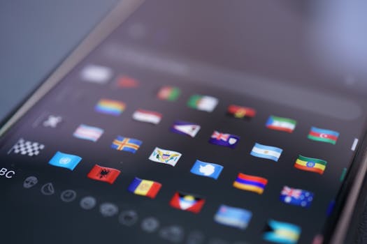 Close-up of a smartphone screen displaying a variety of world flags emojis used for digital communication.