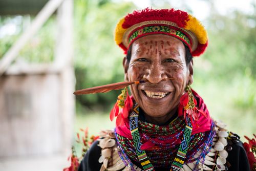 Free Vibrant portrait of an indigenous man in traditional attire with colorful decorations in Ecuador. Stock Photo