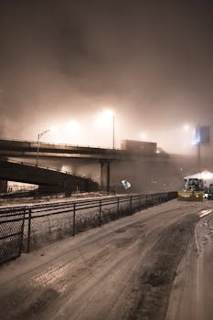 A foggy night scene of elevated highways in Québec, Canada, with lights and snow.