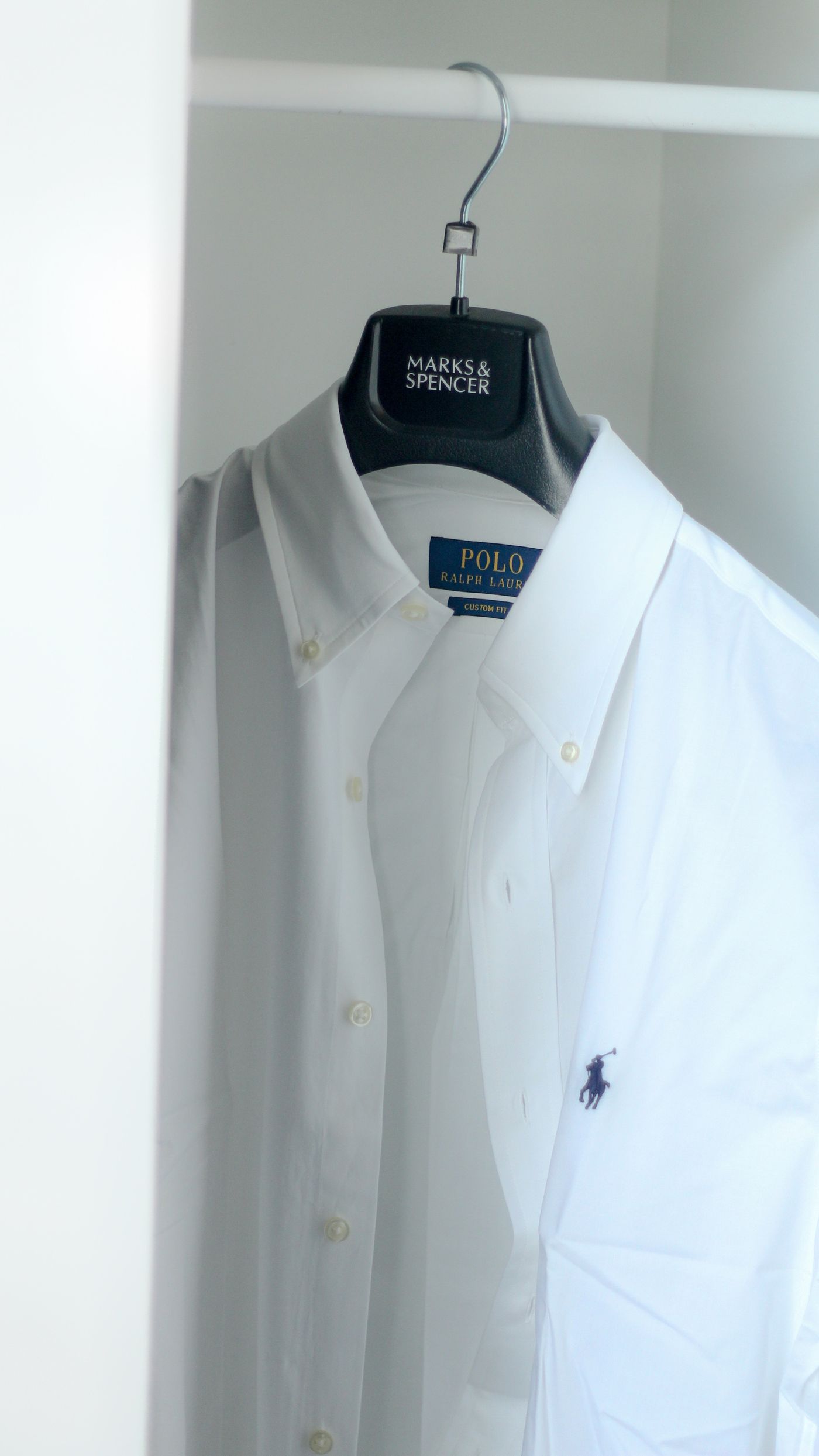 Crisp white shirt displayed in a minimalist wardrobe without people