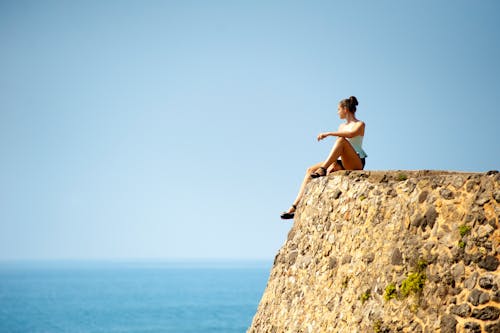 Free Woman Sitting on Edge Stock Photo