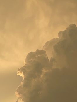 Capture of towering yellow clouds during sunrise in Rajapalayam, India.