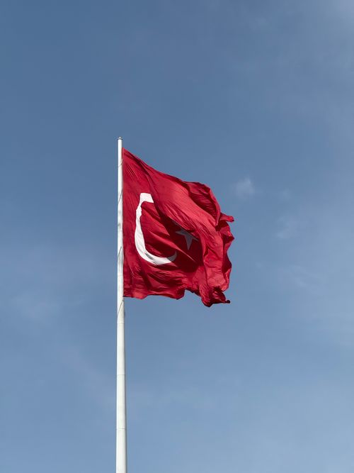 Free Turkish flag waving prominently on a clear day, capturing national pride. Stock Photo