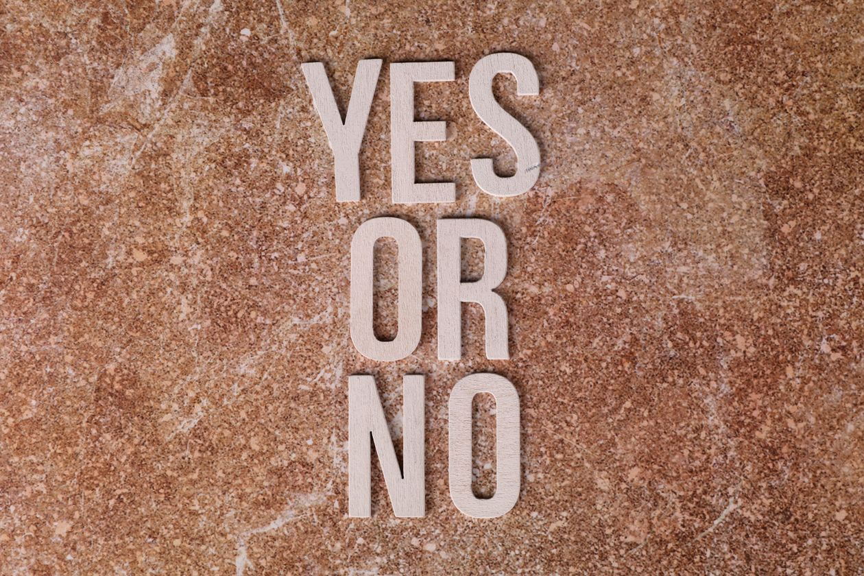 Wooden letters spelling yes or no