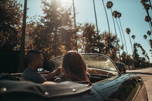 Shallow Focus Photo of People Riding Convertible Coupe