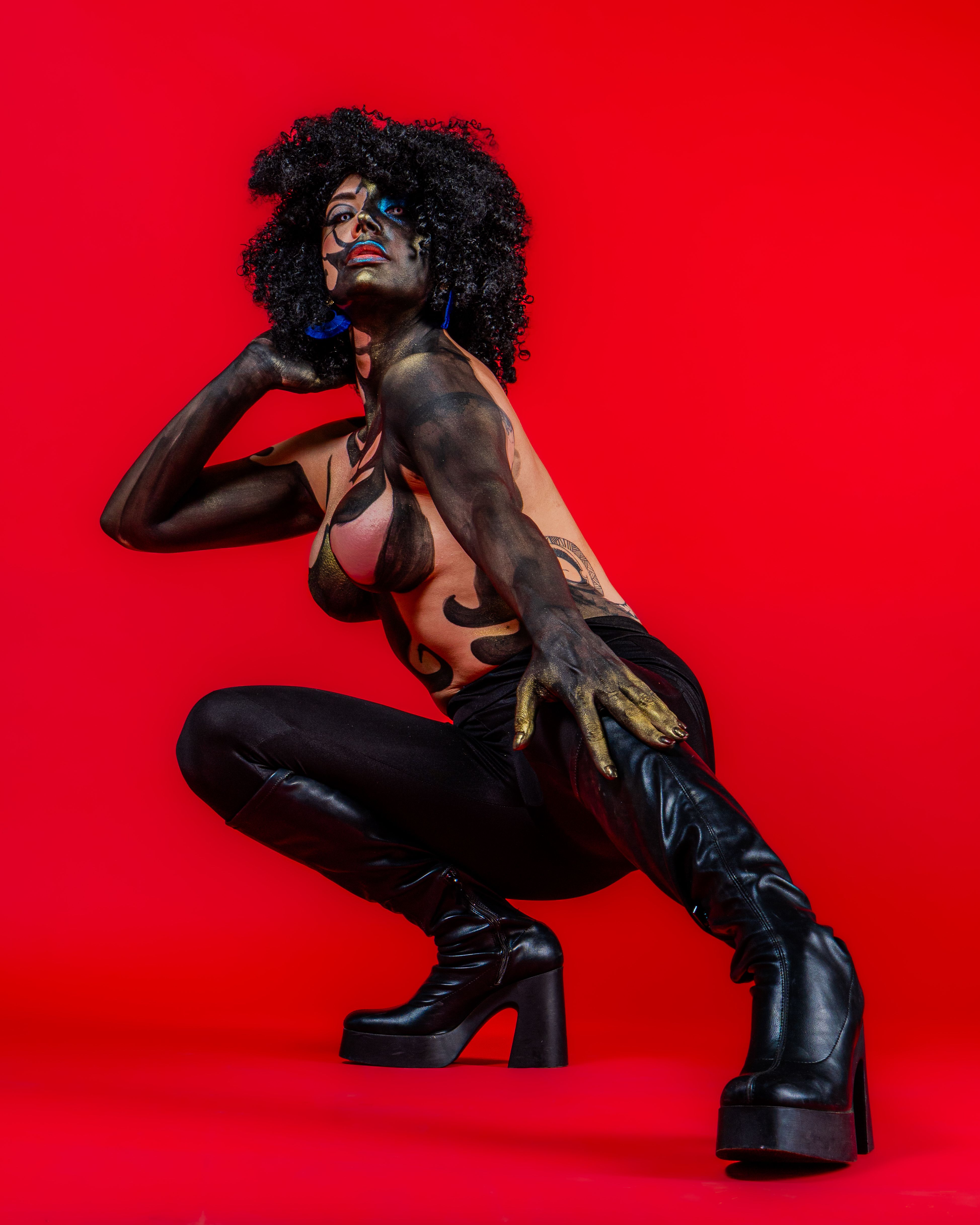 Vibrant Body Art on Bold Red Background · Free Stock Photo