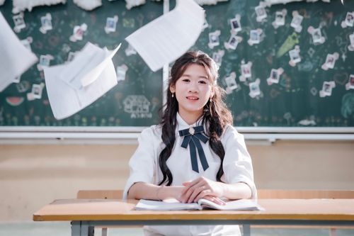 Free Student joyfully smiling with flying papers in a classroom setting, embracing freedom. Stock Photo