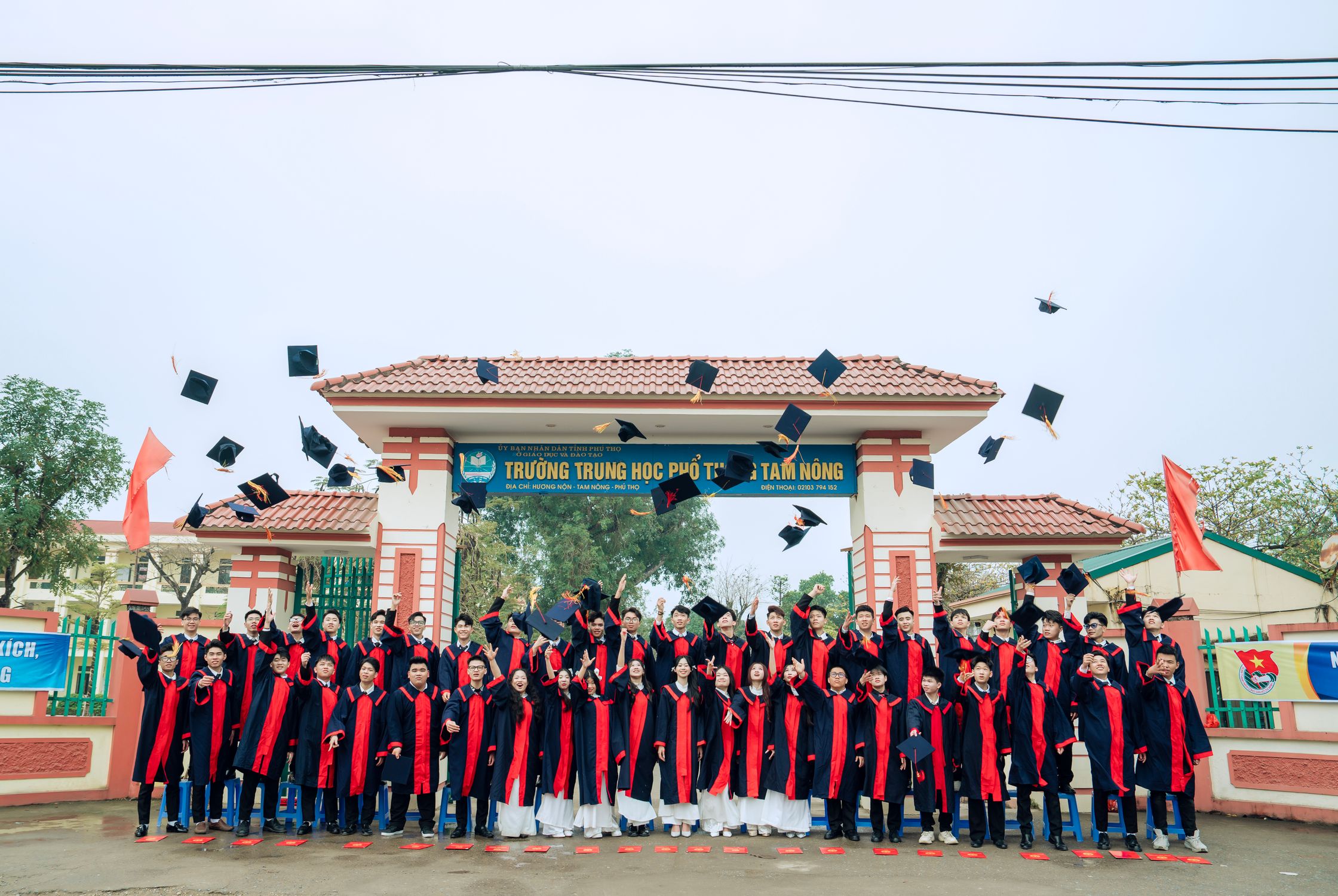 High School Graduation Celebration Outside School Gate · Free Stock Photo