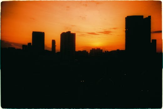 Film capture of Singapore skyline with stunning sunrise hues and silhouetted buildings.