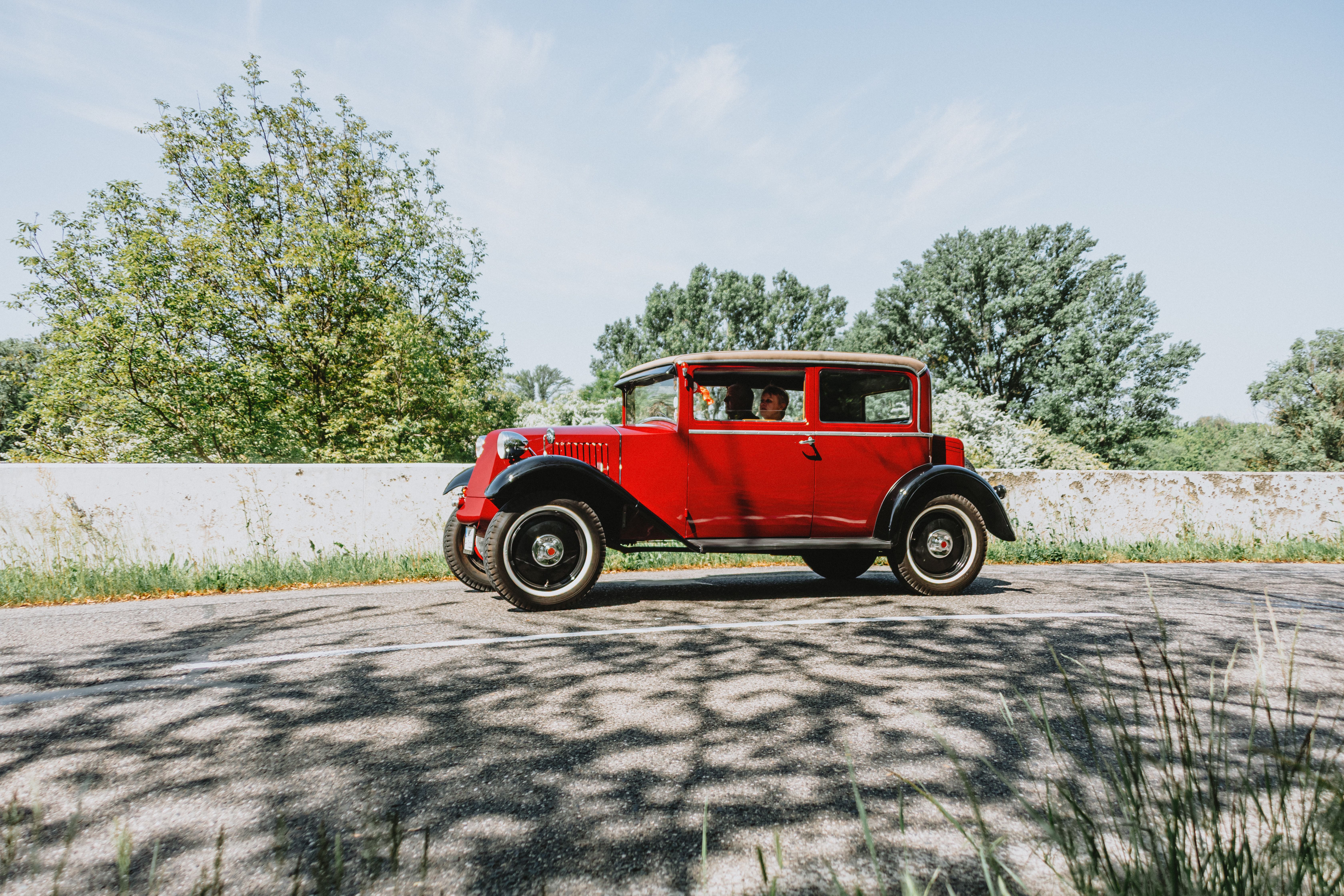 Vintage Red Car on Sunny Outdoor Road · Free Stock Photo