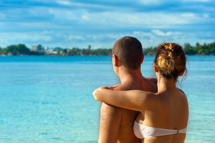 Woman Embracing Man Near Water