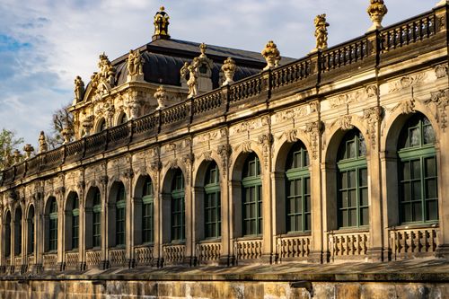 Free Stunning facade of Zwinger Palace in Dresden showcasing intricate Baroque architecture under a warm sunset. Stock Photo