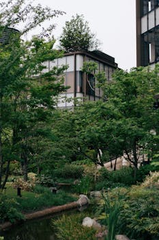 A tranquil urban garden with modern buildings in Tokyo, Japan.