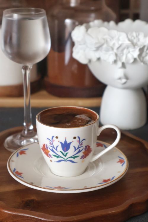 Free Intricately decorated coffee cup and glass on wooden tray, elegant setup. Stock Photo