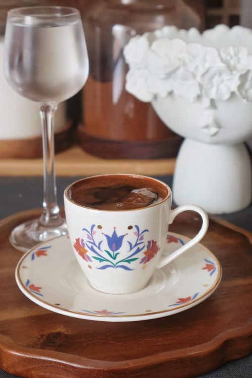 Free Artistic shot of Turkish coffee in a floral cup with elegant dining table setup. Stock Photo