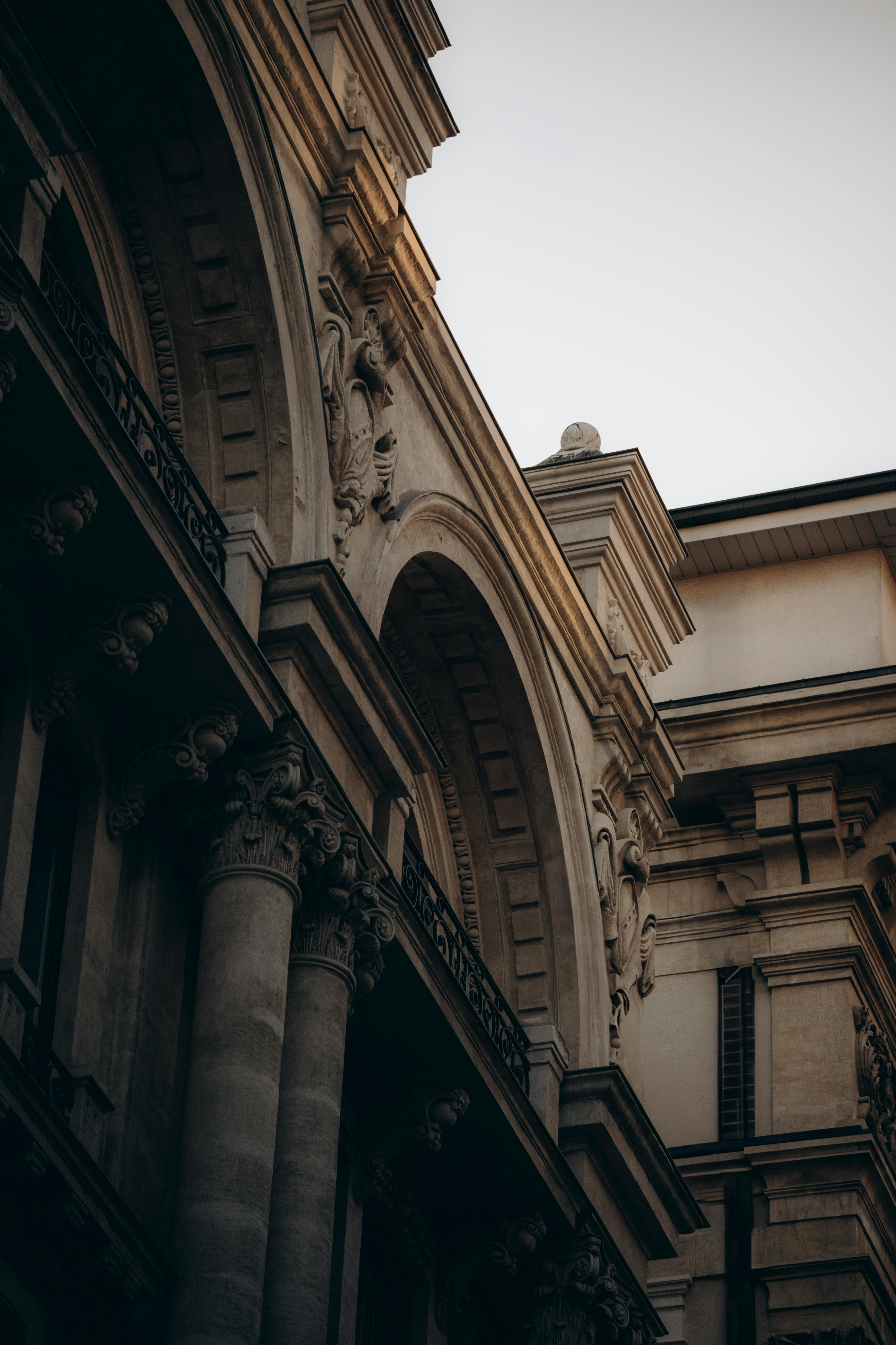Dramatic view of a historic building's detailed columns and arches with classic architecture.