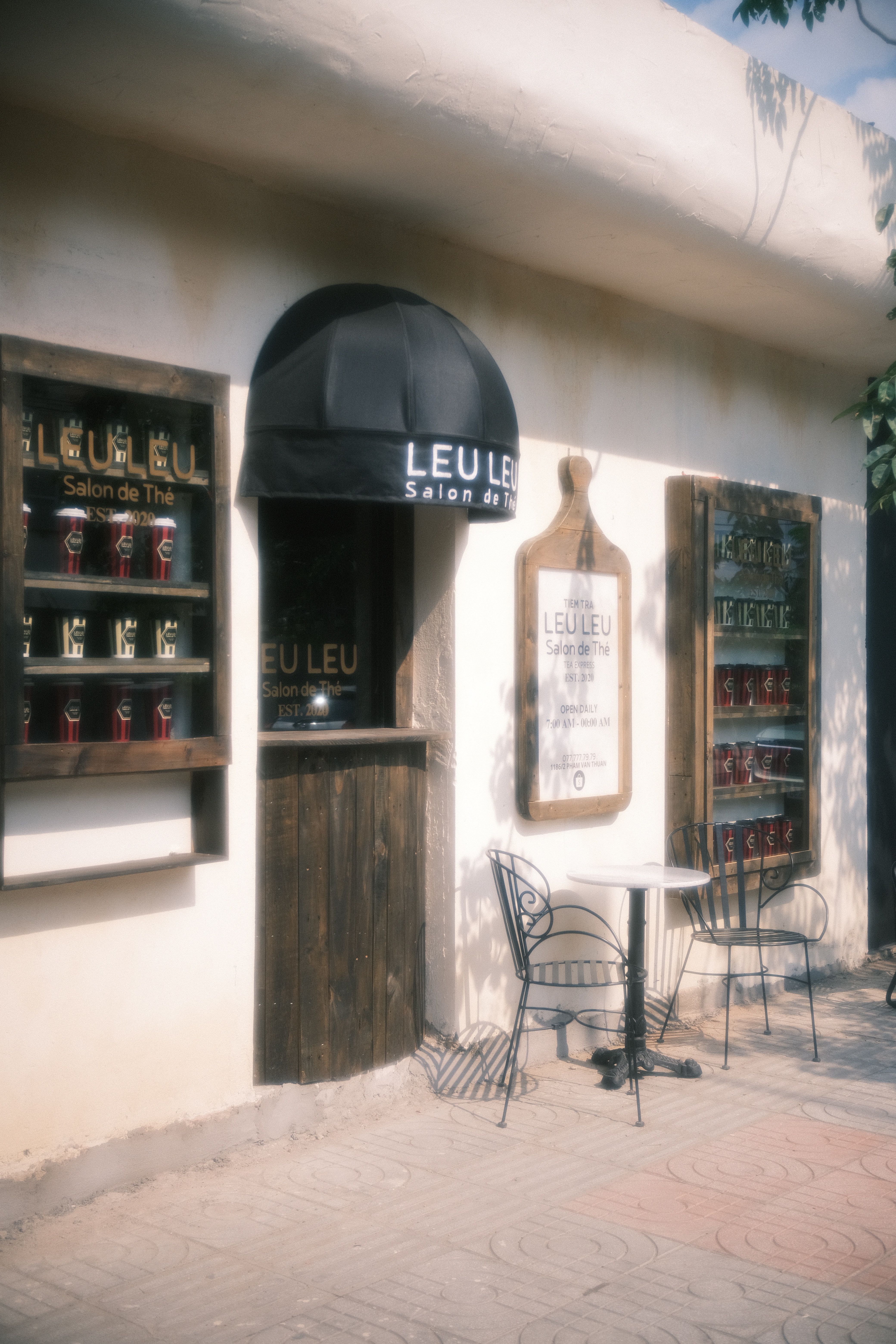 Charming outdoor café with vintage decor and stylish seating, perfect for a relaxing break.