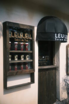 Exterior of a vintage tea salon with signage and cozy decor, evoking charm.