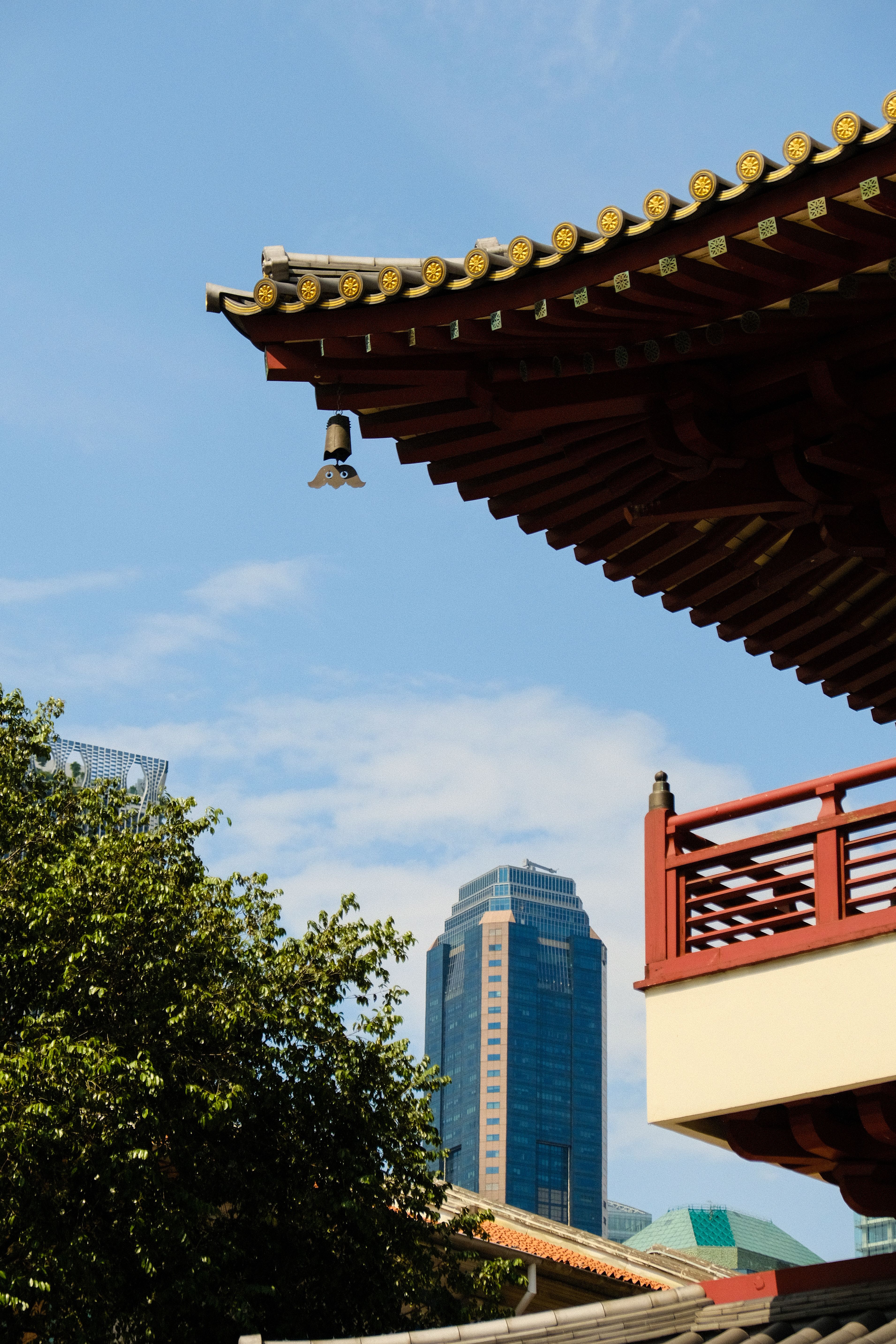 Traditional Temple Roof with Modern Skyline · Free Stock Photo